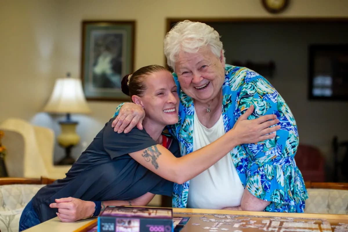Family Resource Home Care caregivers sharing a warm moment with a client at home